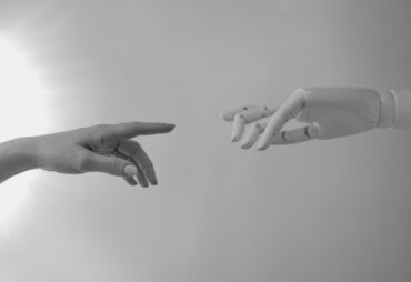 Human hand and robot hand about to touch